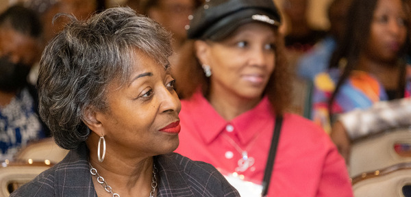 Image of two senior citizens listening attentively to a presentation