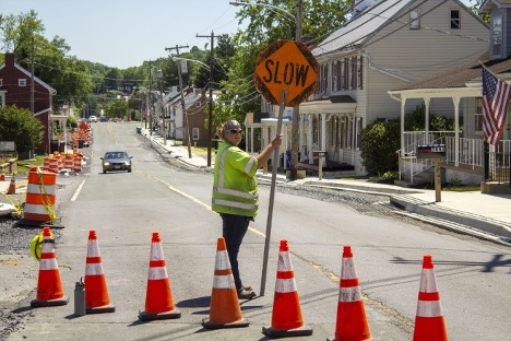 NWZAW Go Slow sign orange cones street scene