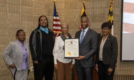 Staff pose with the Governor's Proclamation for 6888th Postal Battalion Day
