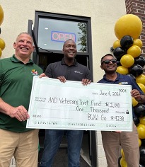 buffalo wild wings go in howard county presents a check to DVMF