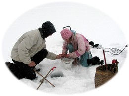 ice fishing hole with young man and girl watching the line