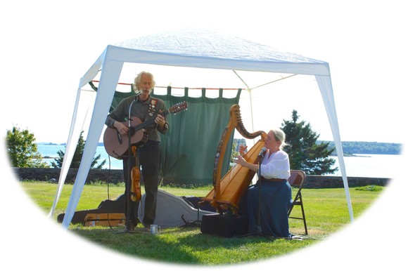 Castlebay, a muscial duo consisting of a guitar and harp player, in period dress giving traditional concert at Colonial Pemaquid State Historic Site