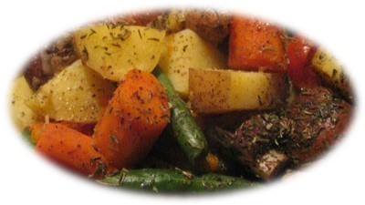 Roasted root vegetables including potatoes, carrots, onion, clove garlic, tomatoes, and green beans.
