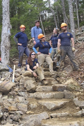 Team Leaders standing on a staircase they built.