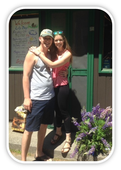 A honeymooning couple hugs at Lily Bay State Park entrance booth