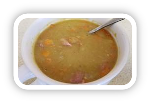 Homemade pea soup with chunks of carrots and ham.