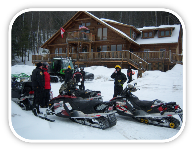 Snowmobile riders taking a coffee break outside the Hawksnest lodge.