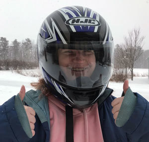 Snowmobile rider giving two thumbs up.