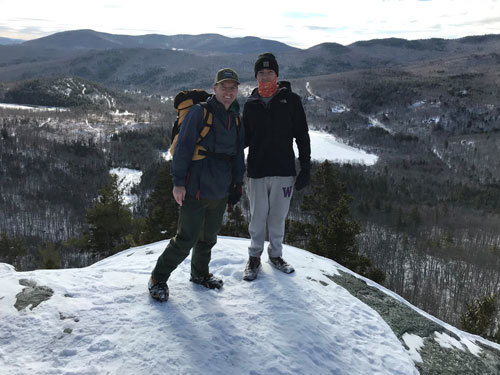 Andy and Haven on the summit of bald Mountain with an expansive view overlooking Little Concord Pond, Maine.