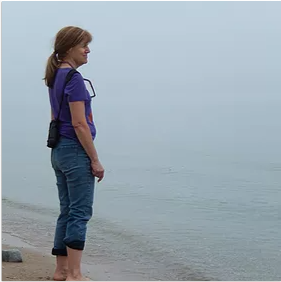 Marty Kotter on a beach at water's edge.