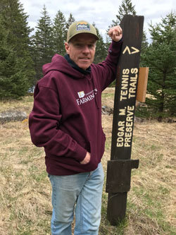 Andy Cutko, Maine Bureau of Parks and Lands Director, at Edgar M. Tennis Preserve Trails sign.