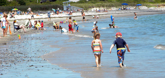 Beach walkers and sunbathers at Crescent Beach State Park, Maine.