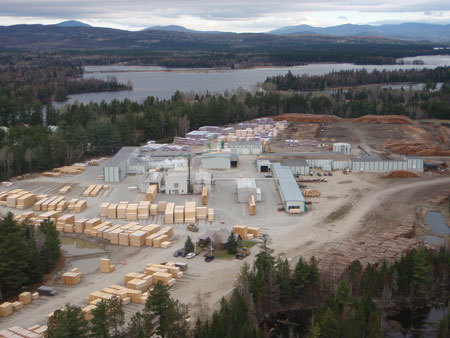 Stratton Lumber Mill aerial shot with lake and mountains in background.