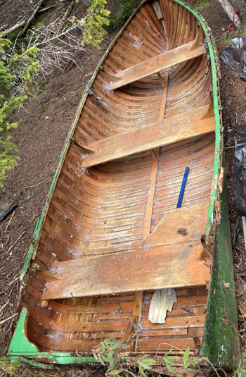 Boat left to rot  on the shoreline of Cold Stream Public Land, Maine.