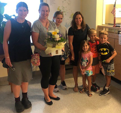 InforME staff and family members delivering flowers to Charlene Daniels for her retirement.