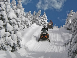 Snowmobile riders on the Coburn Summit Trail.