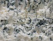Blue veining of a cheese in close-up.