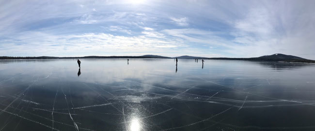 Tunk Lake on a cold winter day with ice skaters enjoying the ice. Photo by Jacob van de Sande.