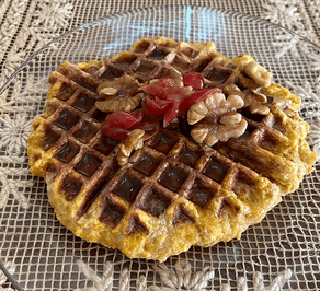 Sweet potato waffles garnished with cranberries and maple syrup. Photo by Jocelyn Hubbell.