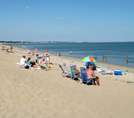 Beach with beachgoers at Ferry Beach State Park.