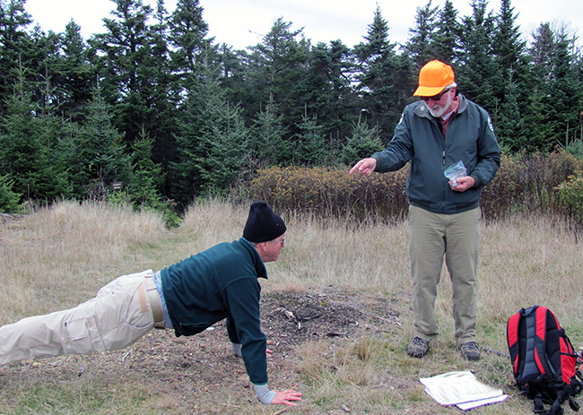 Will Harris humorously putting a staff member through their paces (push-ups) in 2010. 