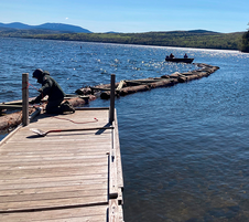 Crew installing the wave attenuator at the boat ramp at Rangeley Lake State Park.