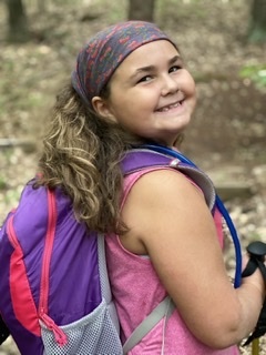 Youngster with backpack on a hike at Androscoggin Riverlands.