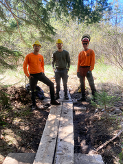 Maine Conservation Corps Team Leaders with bog bridging they made at Cutler Coast Public Land.