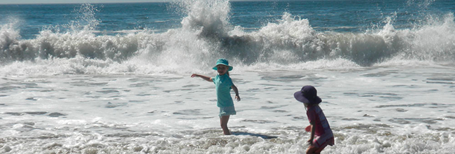 Children playing in the surf at Reid State Park. Photo by Ellen Wood.