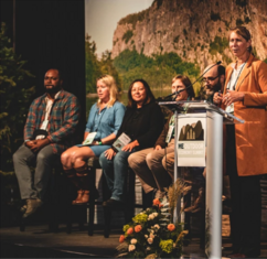 Carolann Ouellette, Director, Office of Outdoor Recreation, Maine DECD at the podium during a Maine Outdoor Economy Summit.