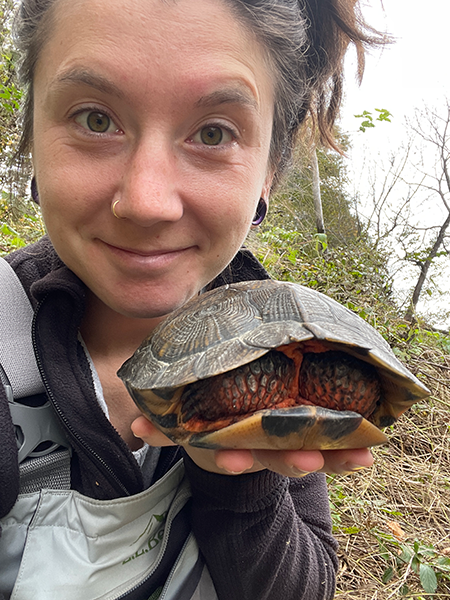Wildlife Technician Adrianna Bessenaire with a turtle.