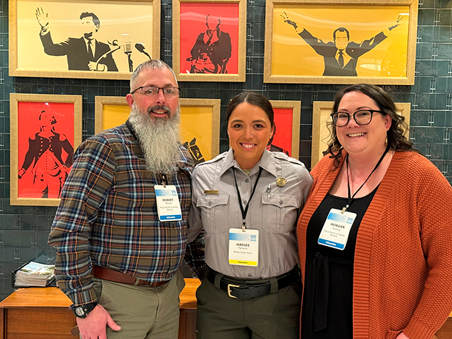 Reid State Park Manager Haylee Parsons with her parents at a DOD conference in Washington, DC.