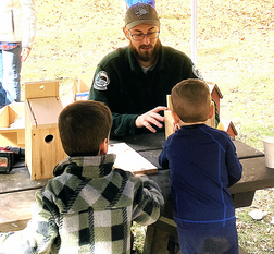 Kevin Miller helping children build bird houses.