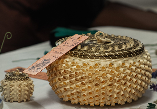 Woven basket. U-Mainee Hudson Museum photo advertising the Wabanaki Winter Market 2025.