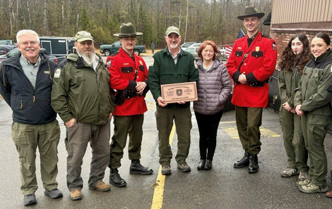 Allagash Wilderness Waterway Chief Ranger, receiving a Maine Warden Service Merit award with Wardens and Rangers beside him.