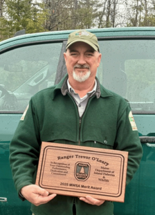 Chief Ranger Trevor O'Leary with his Merit Award plaque from the Maine Warden Service.