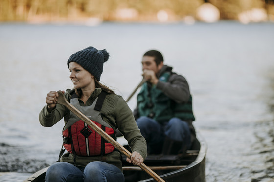 two people paddling a canoe