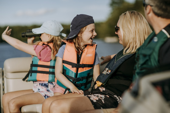 family boating with life jackets on