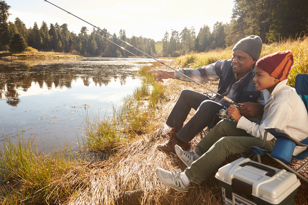 adult teaching kid to fish