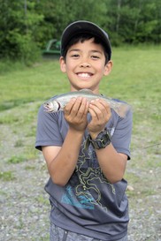 kid smiling holding trout