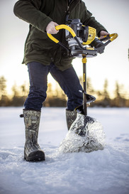 person drilling an ice fishing hole with an auger