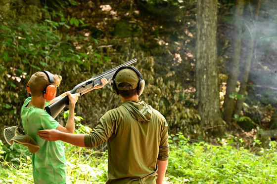 child learning to shoot a shotgun