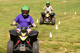 children driving ATVs