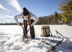 woman setting trap for beaver