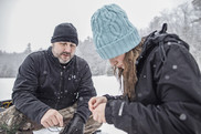 child learning to ice fish