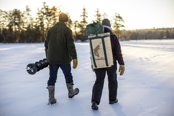 people walking ice fishing