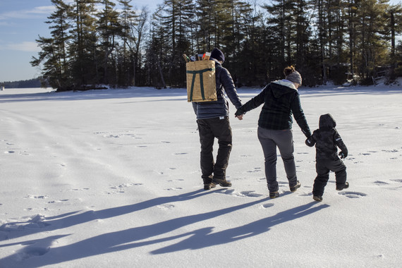 family walking out to ice fishing spot