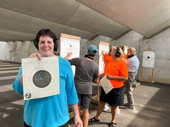 person holding target at firearms workshop