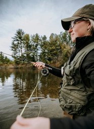 female fly angler on river