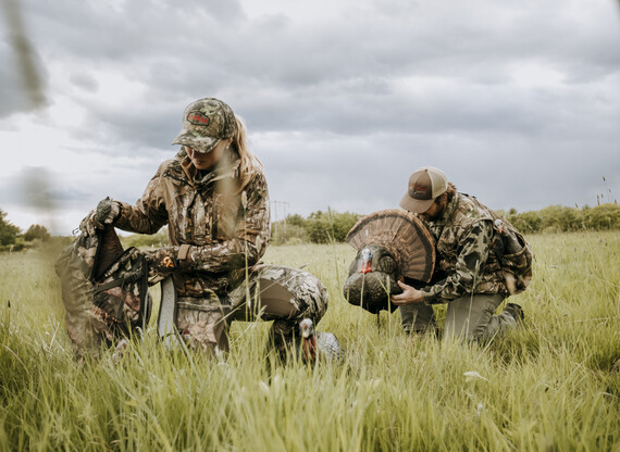 hunters setting turkey decoy